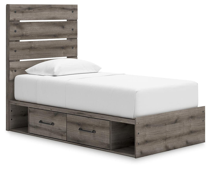 Graystorm bedroom set by Ashley Furniture, featuring a bed, dresser, and nightstands in a modern gray finish, shown from an angled view.