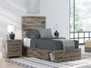 Graystorm bedroom set by Ashley Furniture featuring a bed frame, nightstands, and matching dresser in gray finish.