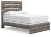 Graystorm bedroom set by Ashley Furniture, includes bed and matching nightstands, shown from an angled view.