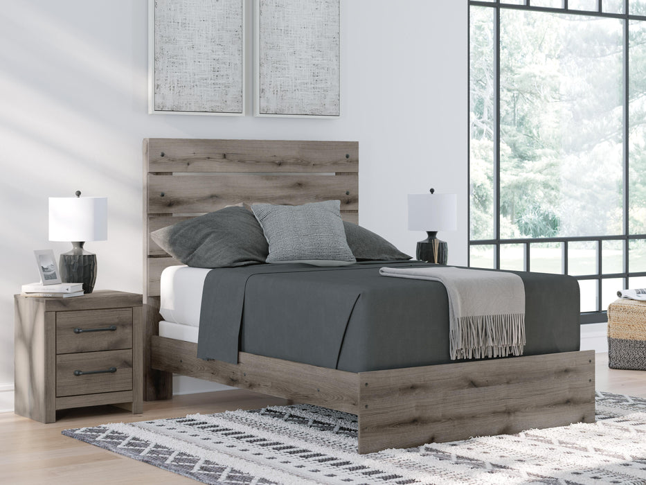 Graystorm bedroom set by Ashley Furniture, featuring a modern bed frame and matching furniture pieces in gray finish.