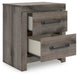 Ashley Furniture Graystorm bedroom set featuring a bed, dresser, and nightstands in a modern gray finish, shown from an angled view.