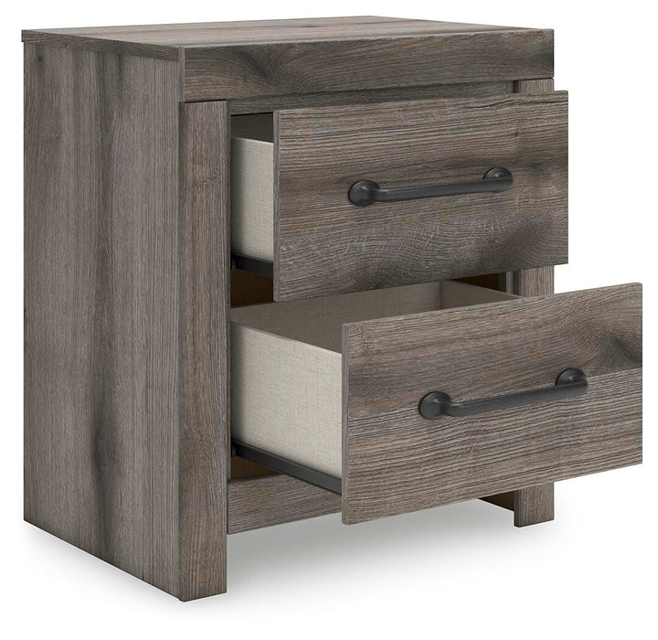 Ashley Furniture Graystorm bedroom set with a bed, nightstands, and dresser shown from an angled view.