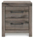Graystorm bedroom set by Ashley Furniture featuring a modern bed frame and matching nightstands in a sleek gray finish.