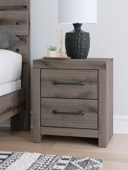 Graystorm Bedroom Set by Ashley Furniture featuring a modern bed frame, matching nightstands, and a coordinated dresser in a gray finish.