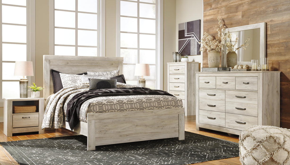 Ashley Furniture Bellaby Bed with a sleek frame and neutral upholstery, shown in a modern bedroom setting.