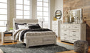 Ashley Furniture Bellaby Bed showing a stylish wooden bed frame with a clean, modern design and a dark finish.