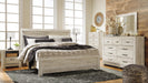 Ashley Furniture Bellaby Bed with elegant wooden frame and headboard, showcasing a modern design in a cozy bedroom setting.