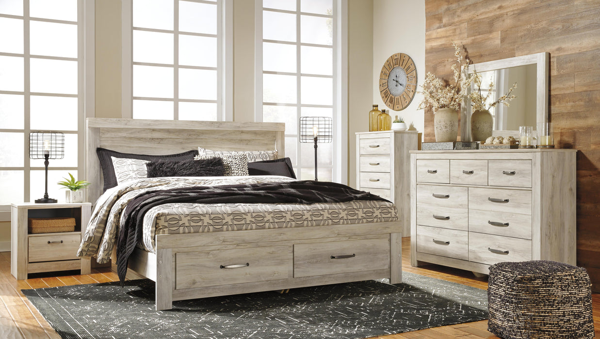 Ashley Furniture Bellaby Bed with a sturdy frame and classic design, shown with the headboard and footboard in a natural wood finish.