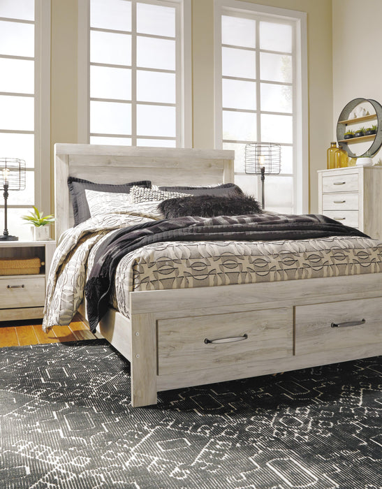 Ashley Furniture Bellaby Bed with upholstered headboard and wooden frame, shown in a modern bedroom setting.