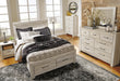 Ashley Furniture Bellaby Bed with a sturdy frame and elegant design, showcasing the headboard and footboard in a modern bedroom setting.