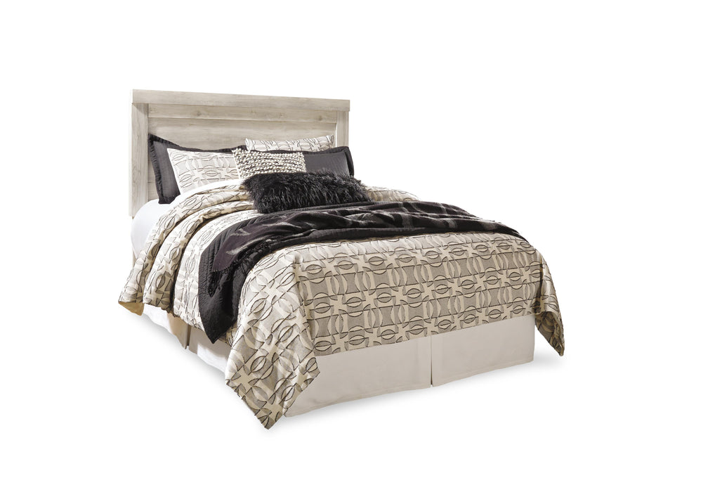 Ashley Furniture Bellaby Bed with a sleek wooden frame and modern design, shown in a close-up of the bed's headboard.