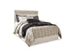 Ashley Furniture Bellaby Bed with a sleek wooden frame and modern design, shown in a close-up of the bed's headboard.