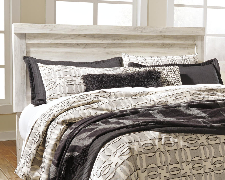 Ashley Furniture Bellaby Bed with a stylish wooden frame and clean design, shown in a close-up shot.