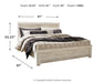 Ashley Furniture Bellaby Bed with upholstered headboard and wooden frame, shown in a stylish bedroom setting.