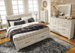 Ashley Furniture Bellaby Bed in neutral fabric with a modern design, featuring a padded headboard and wooden legs.