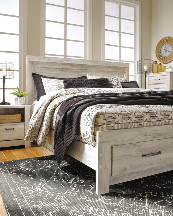 Ashley Furniture Bellaby Bed in a stylish bedroom setup with a wooden frame and plush bedding.