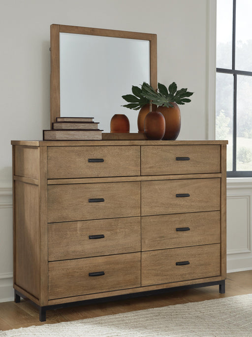 Ashley Furniture Tomtyn dresser with matching mirror, featuring a sleek wood finish and modern design in this close-up image.