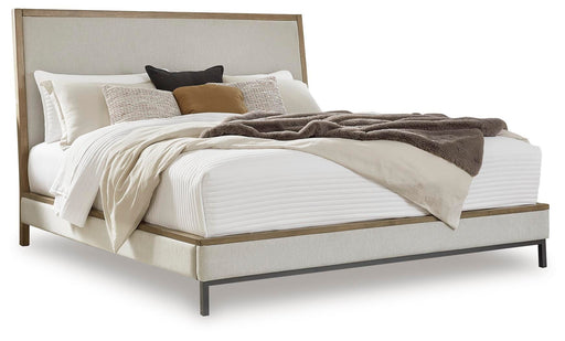 Ashley Furniture Tomtyn upholstered bed with a plush fabric headboard and sleek frame, showcasing a modern bedroom style.