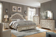 Ashley Furniture Realyn bedroom set featuring a bed, nightstands, and dresser with a modern design in a cozy bedroom setting.