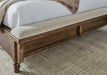 Close-up of the Ashley Furniture Sturlayne upholstered bed with detailed fabric headboard and frame in a modern bedroom setting.