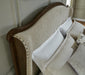 Close-up of the Ashley Furniture Sturlayne upholstered bed frame with detailed fabric and sturdy wooden construction.