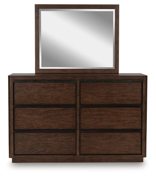 Ashley Furniture Dilenno bedroom set with a large bed frame featuring a headboard, nightstands, and matching dresser in a cozy bedroom.