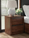 Ashley Furniture Dilenno bedroom set with a stylish bed frame, matching nightstands, and a coordinated dresser in a modern design.