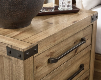 Close-up of Ashley Furniture Ridgester nightstand handle and bracket detail, showing the sleek design and dark finish.
