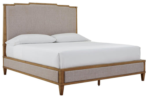 Ashley Furniture Sharlance King Upholstered Bed with plush beige fabric and tufted headboard, shown from an angled side view.