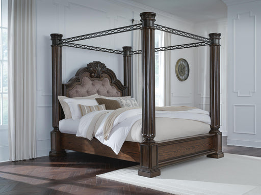 Ashley Furniture Maylee Bed with a stylish upholstered headboard and wooden frame, shown in a cozy bedroom setting.