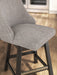Ashley Furniture Neymorton counter height barstool with wooden legs and upholstered seat, shown from a detailed side view.
