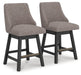 Ashley Furniture Neymorton counter height barstool with wooden legs and upholstered seat, angled view showing stylish design.