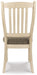 Ashley Furniture Bolanburg dining room set with a table and six chairs, shown from the back view in a modern dining space.