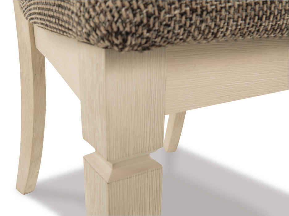 Close-up of Ashley Furniture Bolanburg dining room set with wooden table and matching chairs, detailed view of the table surface.