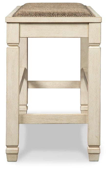 Ashley Furniture Bolanburg dining room set with a wooden table and matching chairs, shown from the side in a modern dining space.