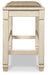 Ashley Furniture Bolanburg dining room set with a wooden table and matching chairs, shown from the side in a modern dining space.