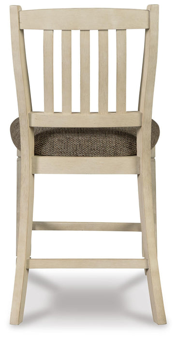 Ashley Furniture Bolanburg dining room set with a wooden table and six matching chairs, shown from the back view.