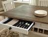 Ashley Furniture Bolanburg dining room set with a wooden table and matching chairs, detailed view of the table surface.