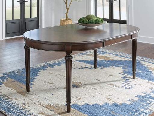 Ashley Furniture Lavinton Dining Extension Table showing a wooden dining table with extendable leaves and modern design.