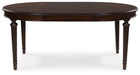 Ashley Furniture Lavinton dining room set with a table and matching chairs featuring leaf pattern accents, shown from a head-on angle.