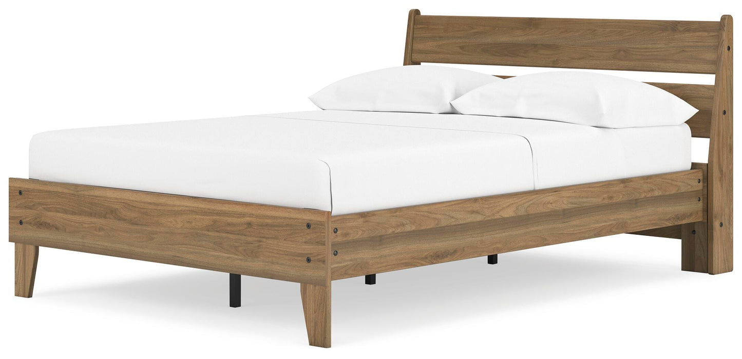 Ashley Furniture Deanlow Bed in warm wood finish, shown from an angled view with detailed headboard and sturdy frame.