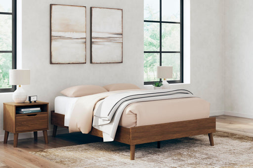 Ashley Furniture Fordmont Bed with a sturdy wooden frame and classic design, shown in a cozy bedroom setting.