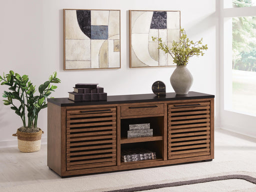 Ashley Furniture Kallari Credenza bookcase with open shelves and storage compartments, finished in a warm wood tone.