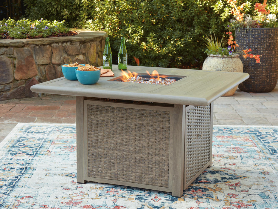 Outdoor fire pit table from Ashley Furniture with a rectangular design, featuring a fire bowl and surrounding surface for outdoor gatherings.