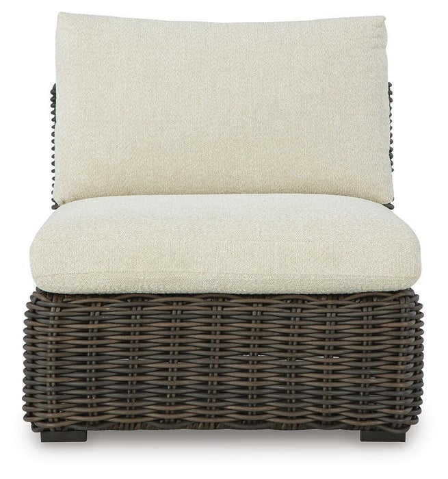 Ashley Furniture Kimora outdoor sectional with cushioned seats and weather-resistant wicker in a modern outdoor seating arrangement.