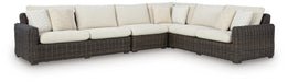 Ashley Furniture Kimora outdoor sectional with plush cushions and stylish wicker frame, ideal for outdoor seating and relaxation.