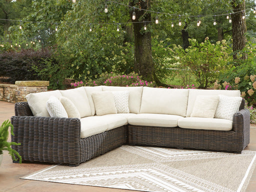 Ashley Furniture Kimora outdoor sectional with cushioned seats and modern design, ideal for patio or garden use.