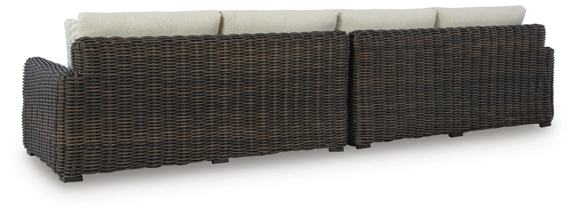 Ashley Furniture Kimora outdoor sectional with beige cushions and dark wicker frame, shown from the back.