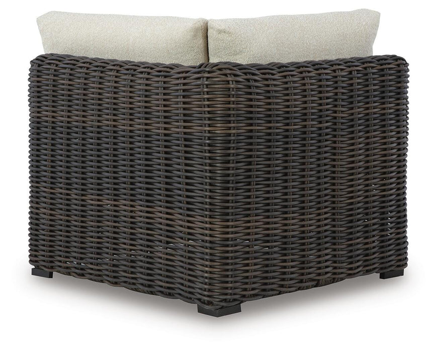 Ashley Furniture Kimora outdoor sectional with cushioned seating and modern design, shown from the back in a stylish outdoor setting.