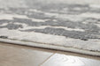 Close-up of Ashley Furniture Mazatl 7'10" x 10'2" rug showing intricate pattern and soft woven texture.